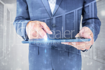 Composite image of  close up view of businessman using tablet co