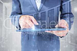 Composite image of  close up view of businessman using tablet co