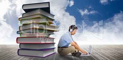 Composite image of side view of man listening music while using