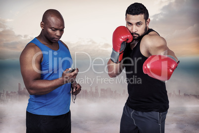 Composite image of boxing coach with his fighter
