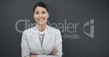 Composite image of smiling businesswoman with folded arms
