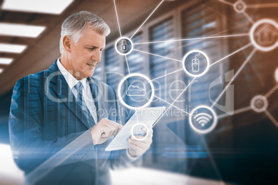 Composite image of businessman using his tablet