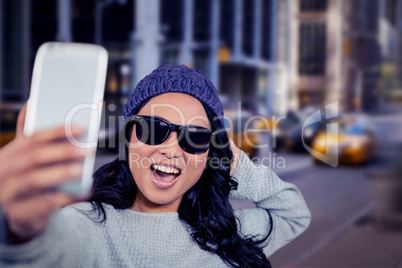 Composite image of asian woman taking selfie