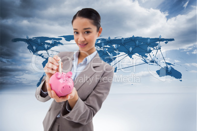 Composite image of portrait of a businesswoman putting a bank no