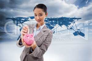 Composite image of portrait of a businesswoman putting a bank no