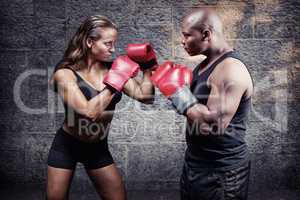 Composite image of male and female boxer with fighting stance