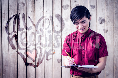 Composite image of smiling hipster takes notes with his smartpho