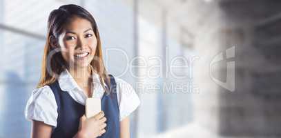 Composite image of smiling businesswoman holding a smartphone