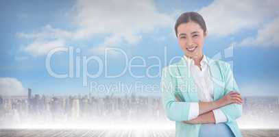 Composite image of smiling businesswoman with folded arms