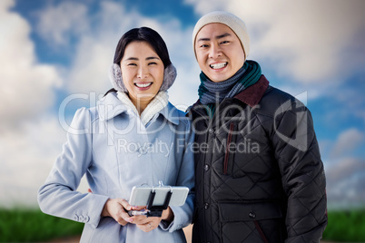 Composite image of cheerful couple against buildings