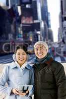 Composite image of cheerful couple against buildings