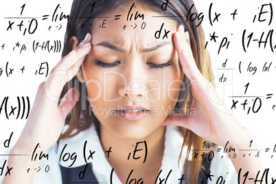 Composite image of nervous businesswoman holding her head