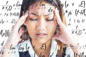 Composite image of nervous businesswoman holding her head