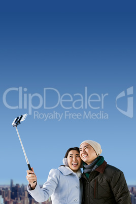 Composite image of smiling couple taking selfie
