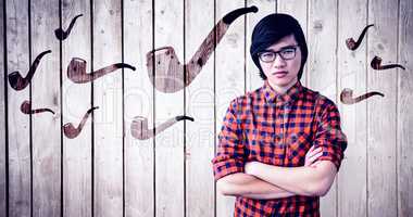 Composite image of serious hipster with crossed arms