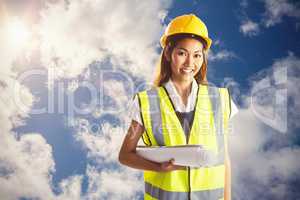 Composite image of architect woman with yellow helmet and plans