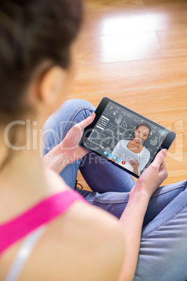 Composite image of woman using tablet at home