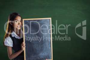 Composite image of smiling businesswoman holding a blackboard