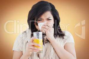 Woman holding a glass of orange juice while sneezing