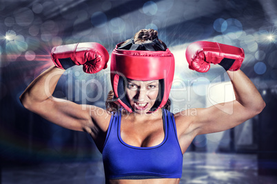 Composite image of portrait of angry female boxer flexing muscle