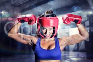 Composite image of portrait of angry female boxer flexing muscle