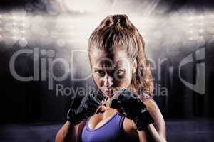 Composite image of portrait of woman with fighting stance