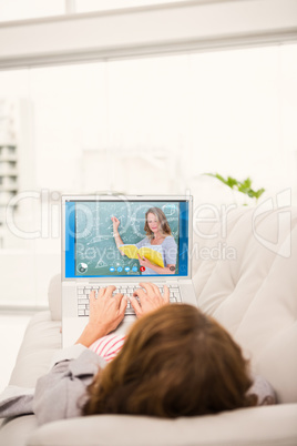 Composite image of teacher reading book while writing on blackbo