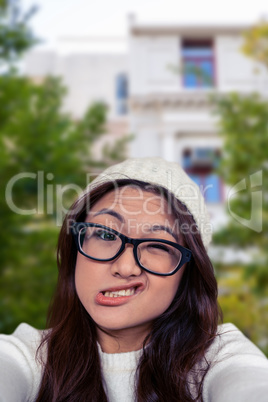 Composite image of asian woman making faces