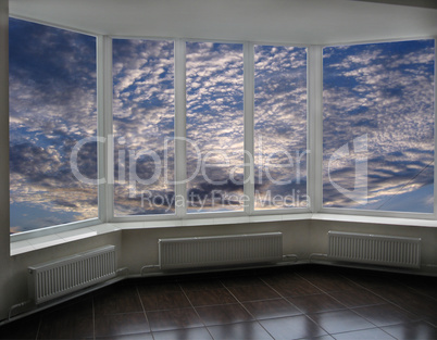 plastic windows overlooking the sunset with clouds