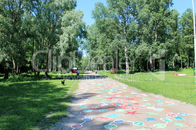 People have a rest in park with big trees