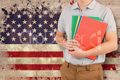 Composite image of mid section of man holding files