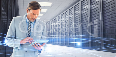 Composite image of concentrate businessman using tablet pc