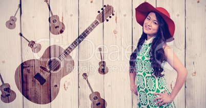 Composite image of asian woman with hat posing for camera