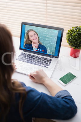 Composite image of thoughtful teacher smiling in front of blackb