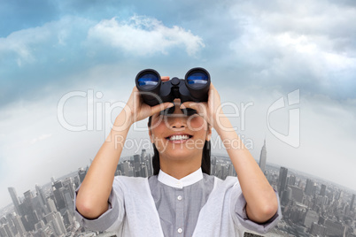 Composite image of visionary businesswoman looking through binoc