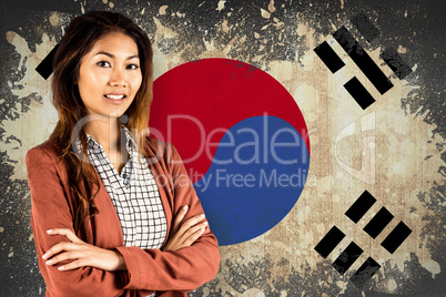 Composite image of smiling businesswoman with crossed arms