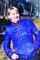 modern fashionable smiling woman in blue jacket