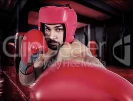 Composite image of muscular man boxing in gloves