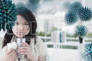 Composite image of sick woman holding a tissue and a glass of wa