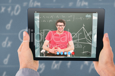 Composite image of businesswoman holding digital tablet