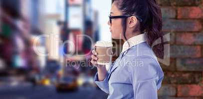 Composite image of businesswoman holding disposable cup and look