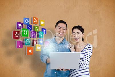 Composite image of portrait of couple using laptop