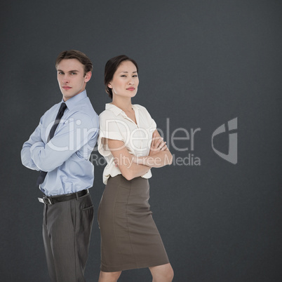 Composite image of business colleagues with arms crossed in offi