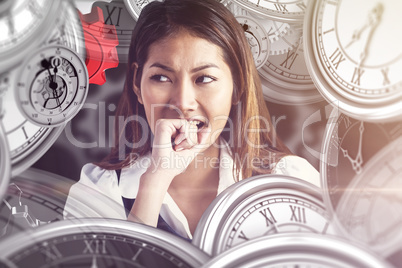 Composite image of businesswoman biting her fist