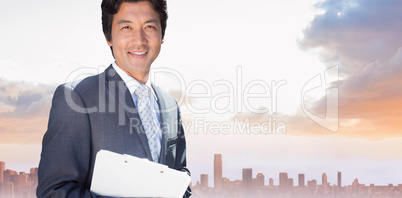 Composite image of confident estate agent standing at front door