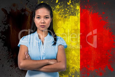 Composite image of serious businesswoman with arms crossed