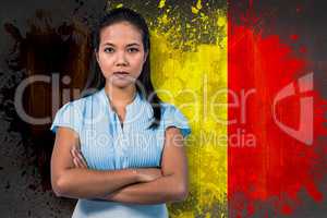 Composite image of serious businesswoman with arms crossed