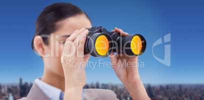 Composite image of brunette businesswoman looking through binocu