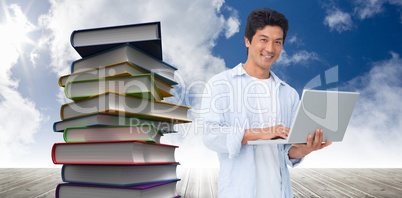 Composite image of smiling male with his laptop