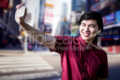 Composite image of hipster man taking a selfie